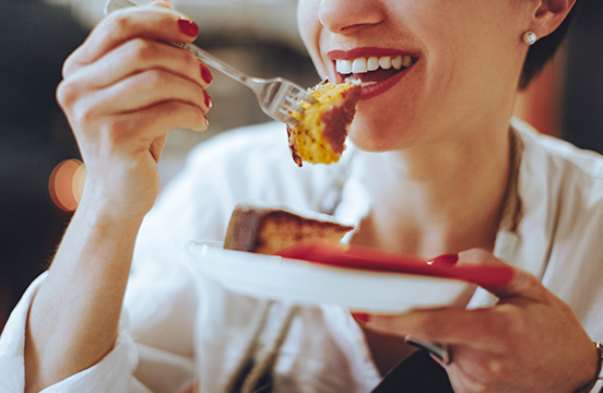 a woman eating a piece of cake